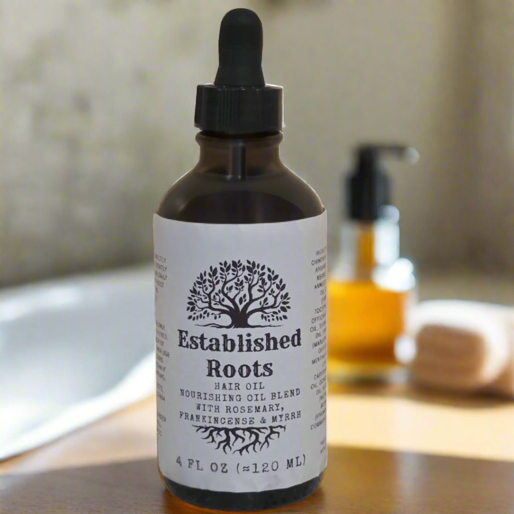 Bottle of 'Established Roots' hair oil with a dropper on a white background